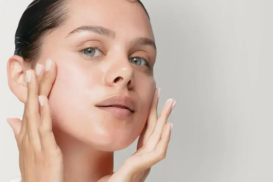 Close-up shot of a model applying face cream or serum, demonstrating how to get glass skin with a clear, intensely hydrated complexion on a White Way Beauty tutorial banner.